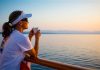 Cruising Solo Woman-Leaning-On-Cruise-Ship-Rail
